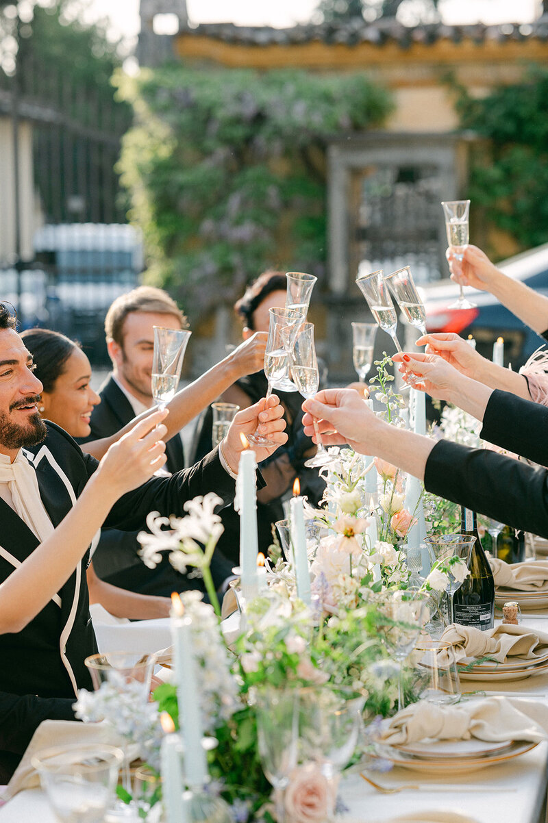 Wedding Party cheers during dinner at an Italy Wedding Venue.