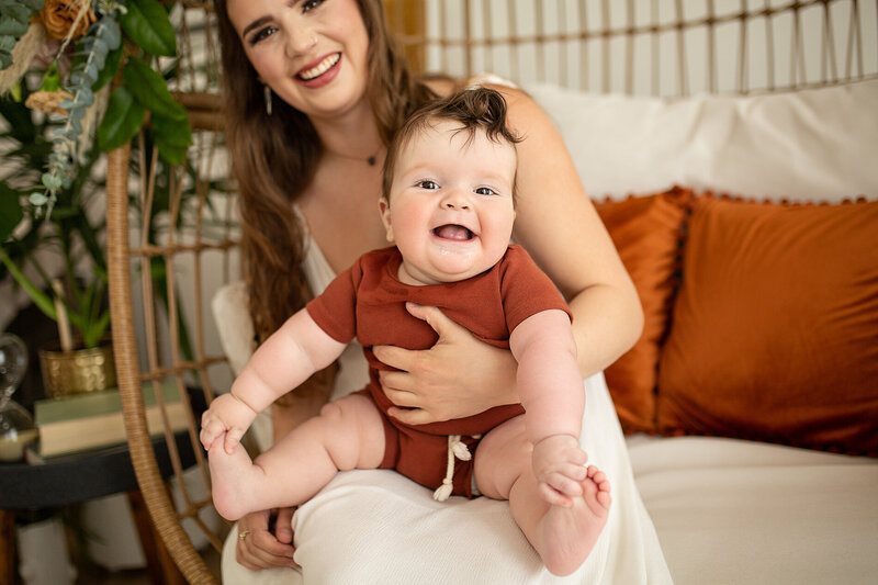 laughing baby boy with rolls