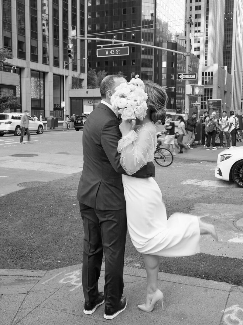 A couple kisses on the street corner during their elopement in midtown NYC