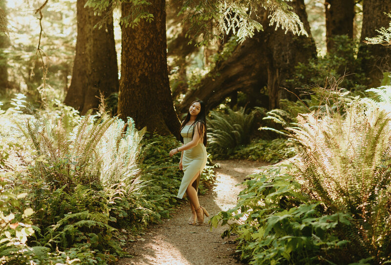 girl posing in floral dress in the forest
