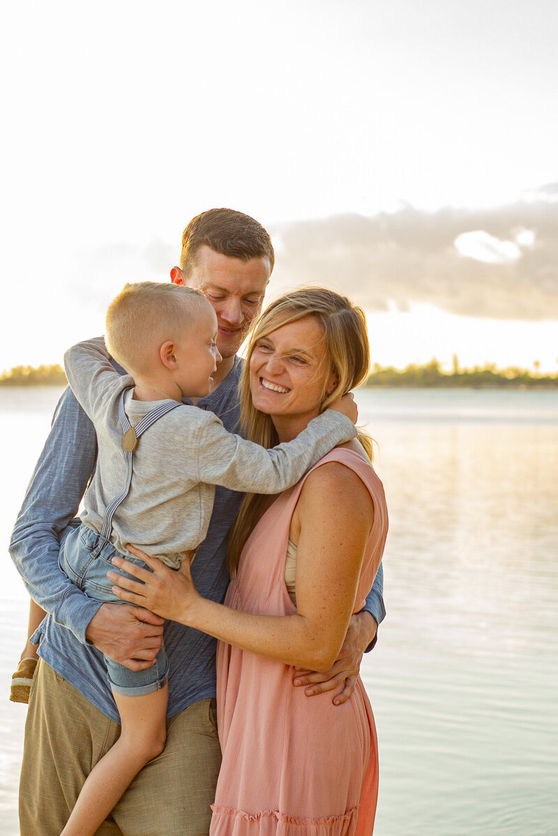 A candid  of a family hugging at the beach captured by Becky Langseth Photography.