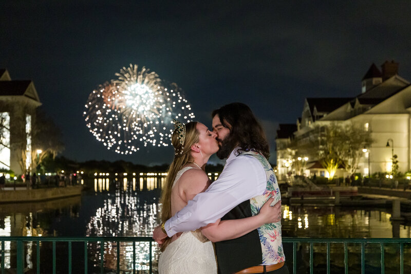 Couple celebrating their Disney wedding with a stunning fireworks display at the Grand Floridian Hotel, overlooking the Magic Kingdom.