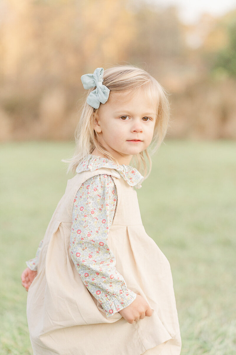close up of little girl while twirling during fall mini session in Loudoun County, Virginia