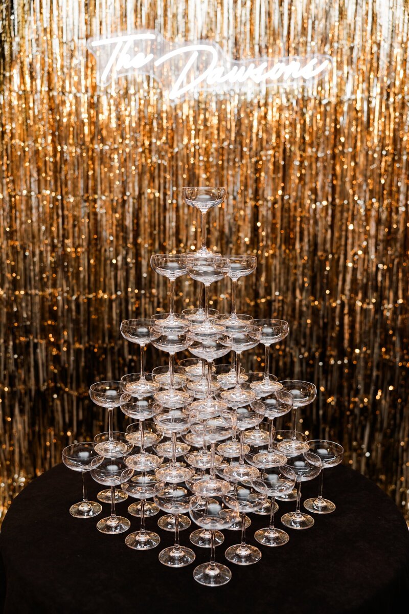"Champagne tower with neon sign at Hotel del Coronado, designed by Thater Made, a luxury wedding and event producer in San Diego, CA.