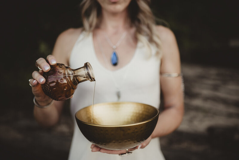 Energy healer Caroline Weiss using a singing bowl and water to support meditation, sound healing, and emotional balance.