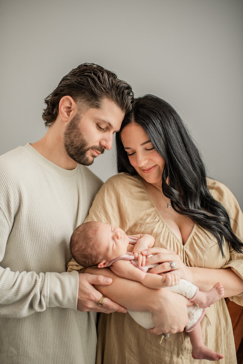 family snuggles at a in-home newborn session in Baltimore, MD