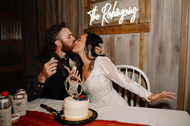 Couple kissing after cutting cake