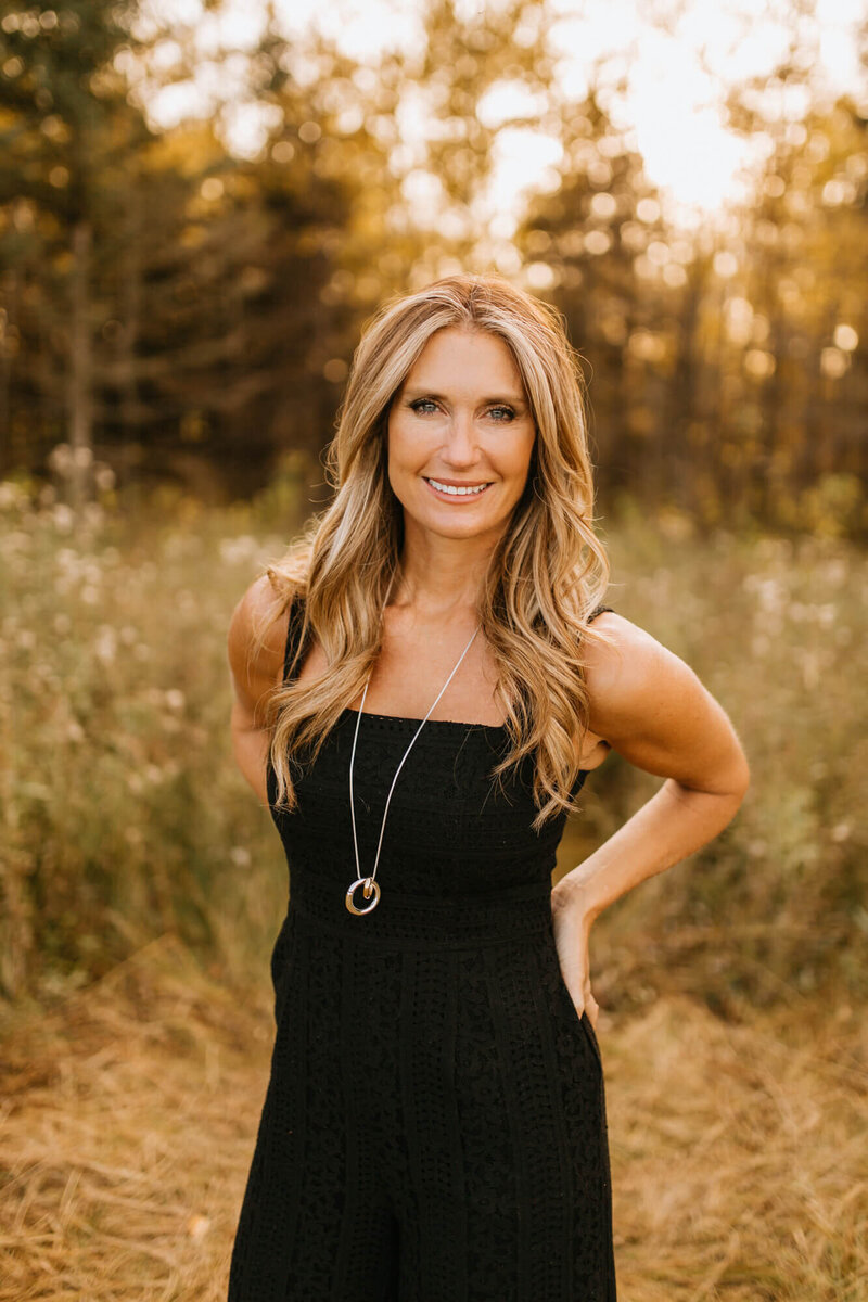 Claudine Lavoie in St Albert park with black outfit and gold necklace