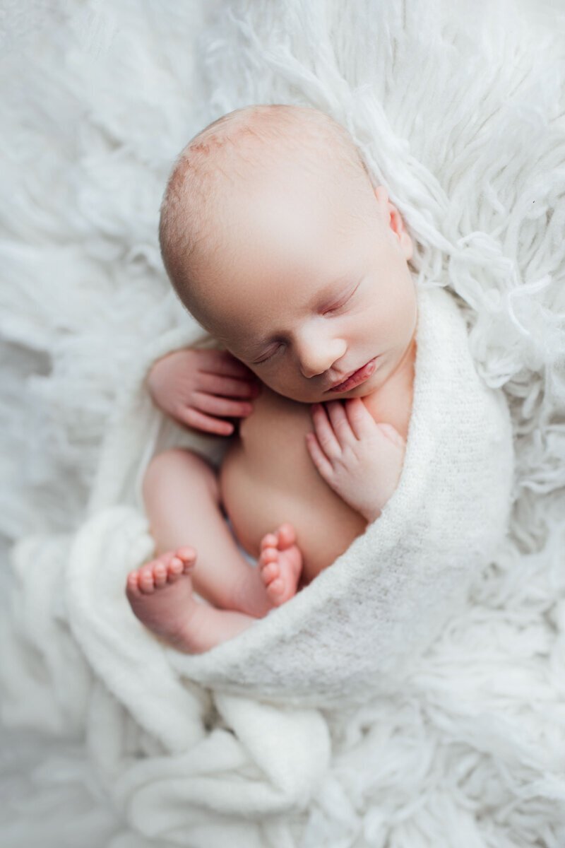 Newborn photography nj of baby swaddled and sleeping peacefully