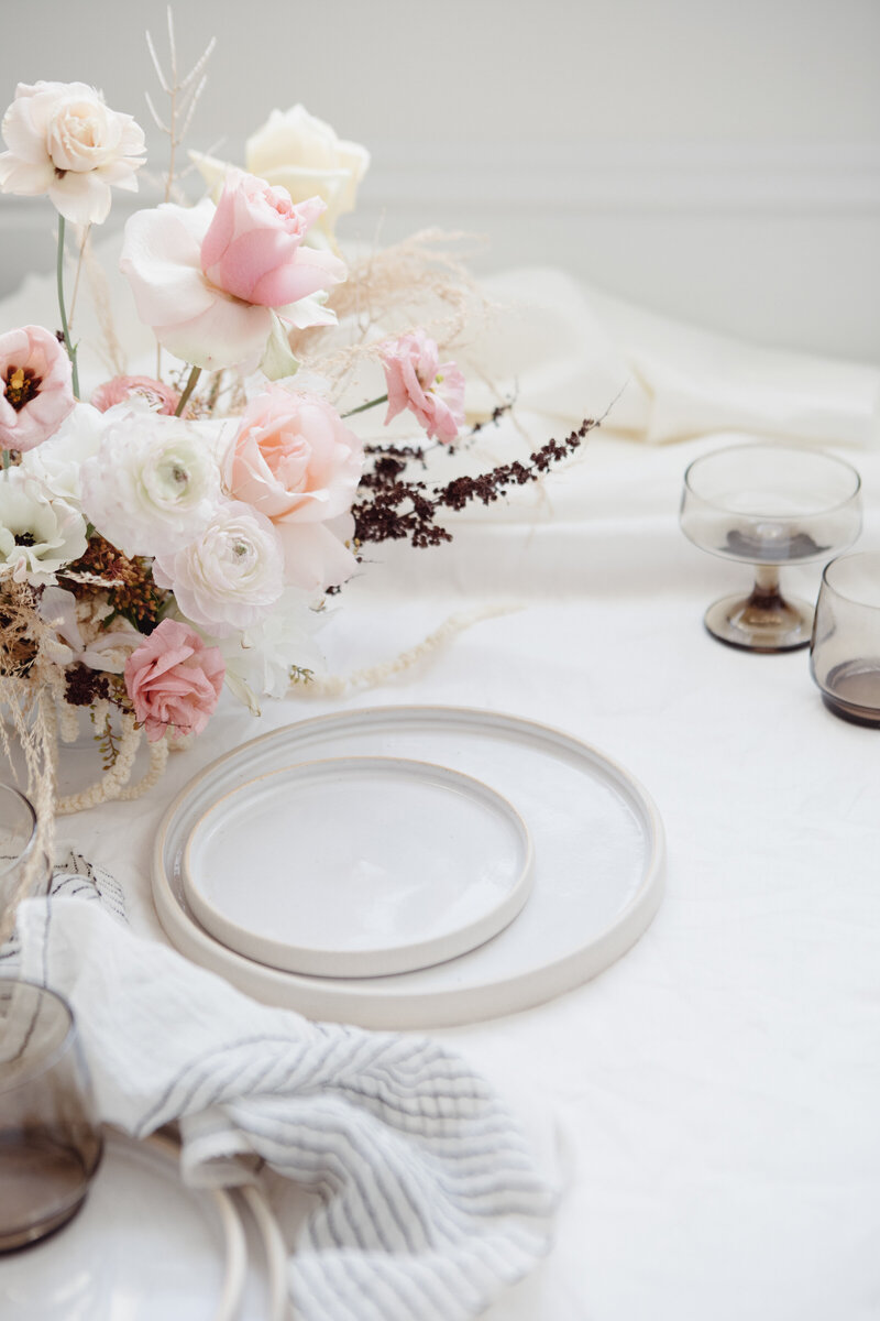 A Pottery Charger and plate on a table with a pink and white florals
