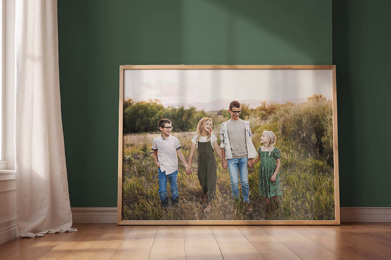 Fort Collins family in a field with mountains behind them