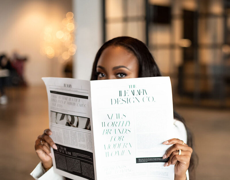 showit website designer looking up from newspaper