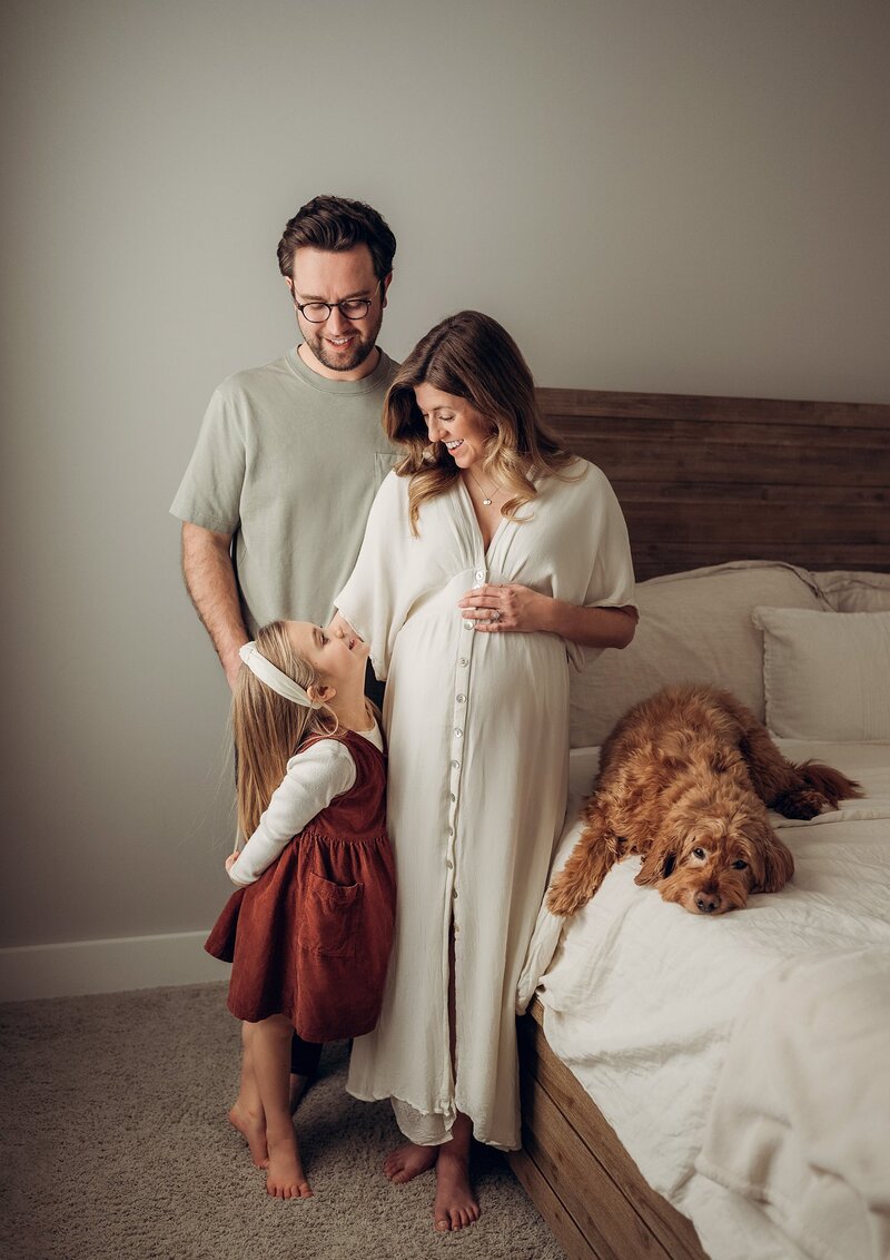 pregnant mom and family in a bedroom