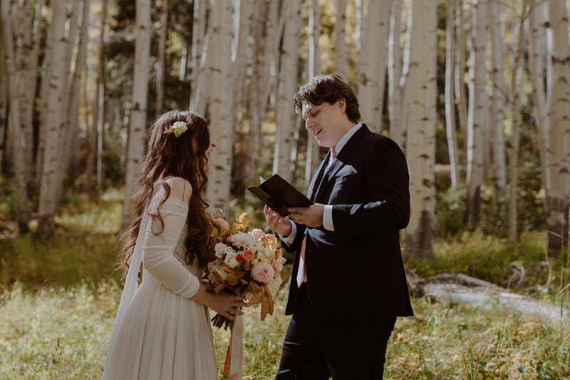 Bride and groom read vows on their elopement day