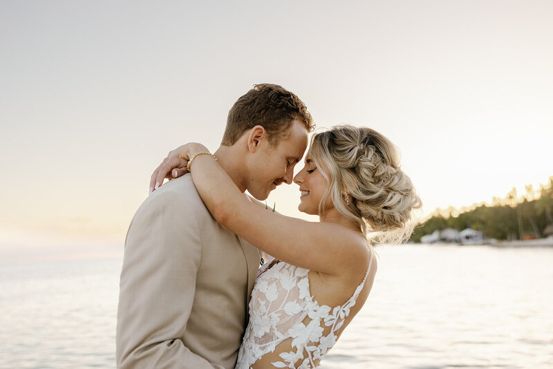 Romantic moment between a bride and groom at sunset on a Miami beach, captured by Claudia Amalia, a wedding and lifestyle photographer based in Miami and Florida Keys, South Florida. Specializing in destination weddings.