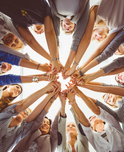 Group of people putting their hands together