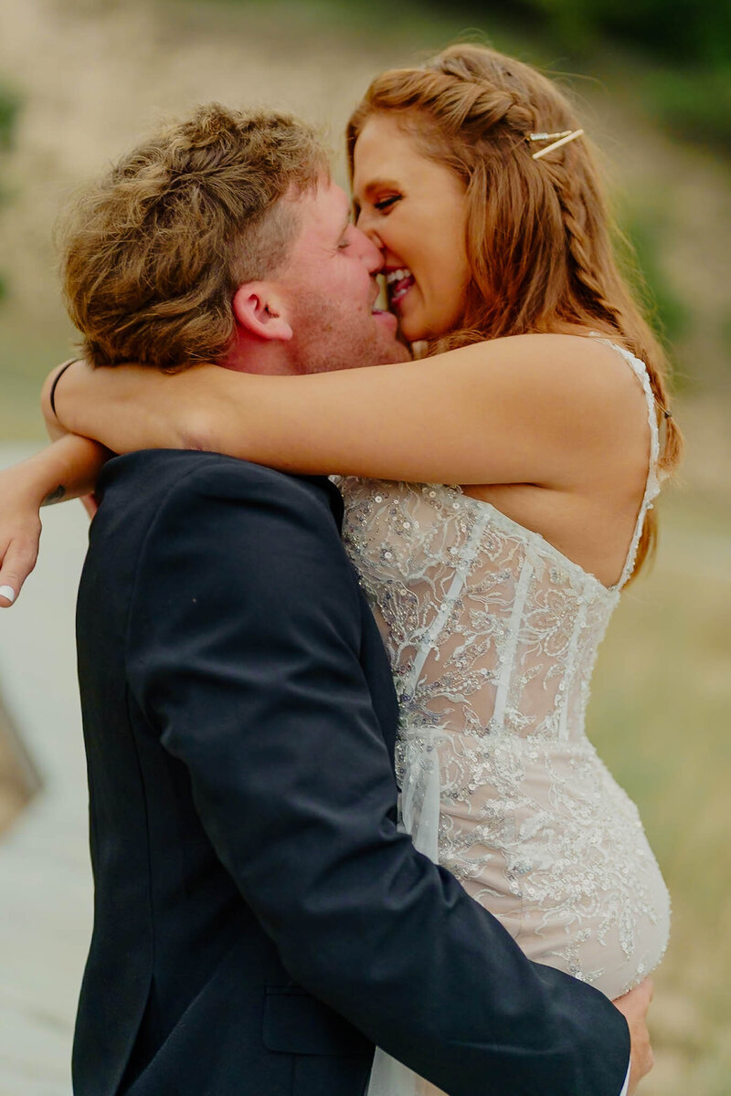 Newlywed couple kissing at beach elopement