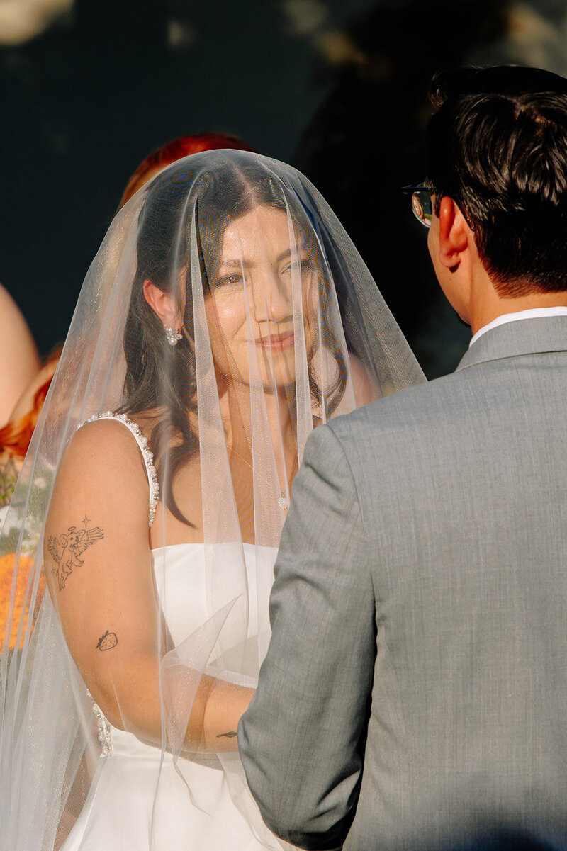 couple laughing together at their long beach wedding