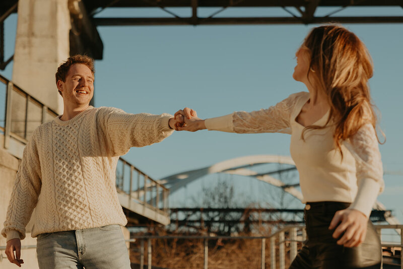 couple holding hands at sunset in downtown nashville