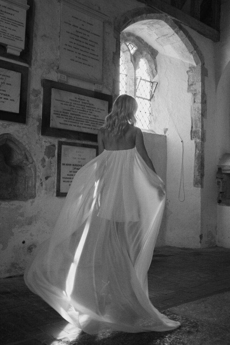 Corset silk flowing wedding dress on bride at church wedding