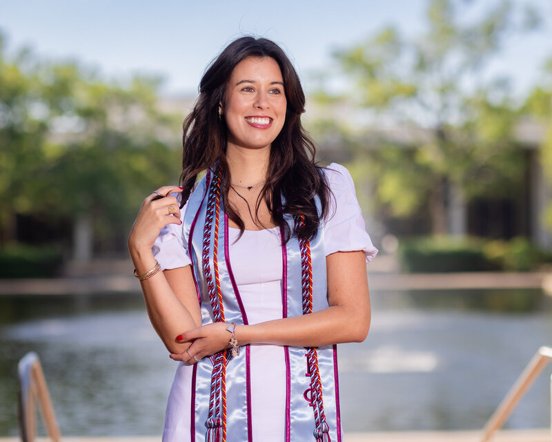 A University of South Carolina student taking her senior portraits  in front of the fountain