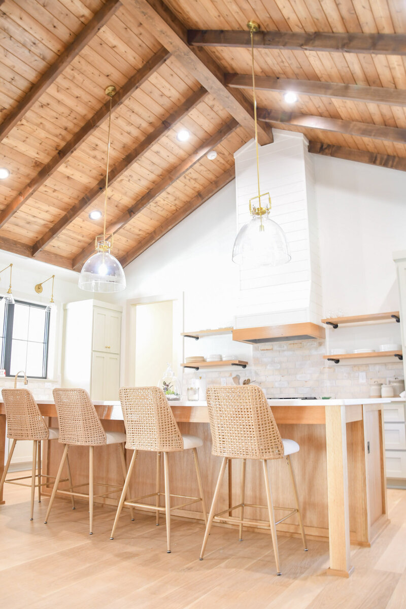 Modern farmhouse kitchen with custom cabinetry and exposed beams.