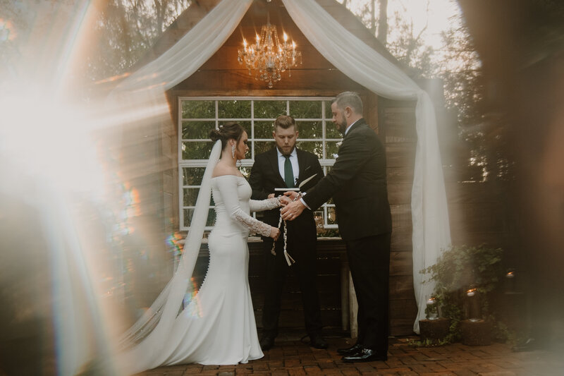 The Intuitive Momma and her husband Bobby exchange vows and hold hands on their wedding day