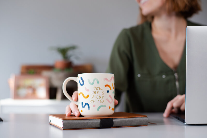 A  tea mug that says "you, me & a cup of tea"