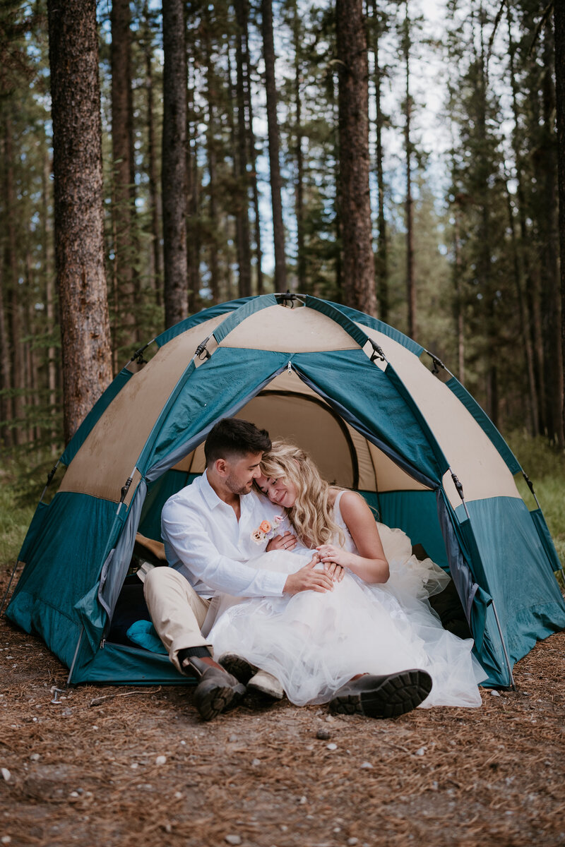Married couple snuggling in their tent