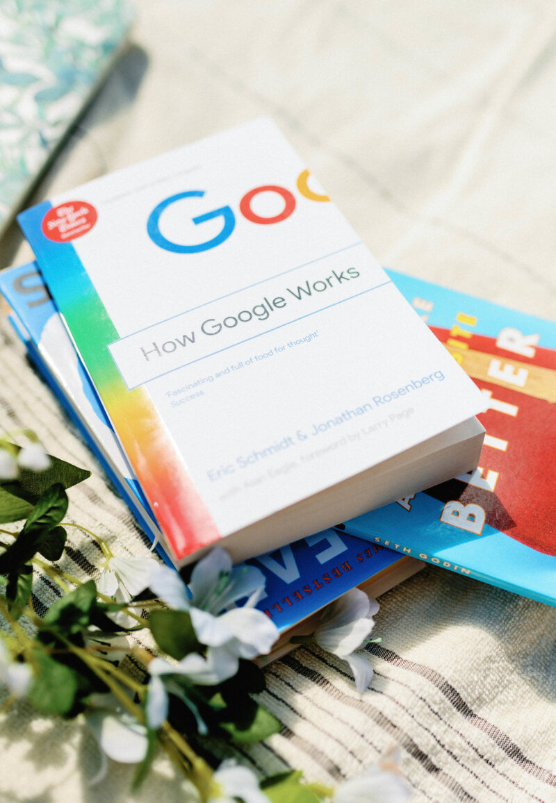 a stack of business books for online and local service based entrepreneurs