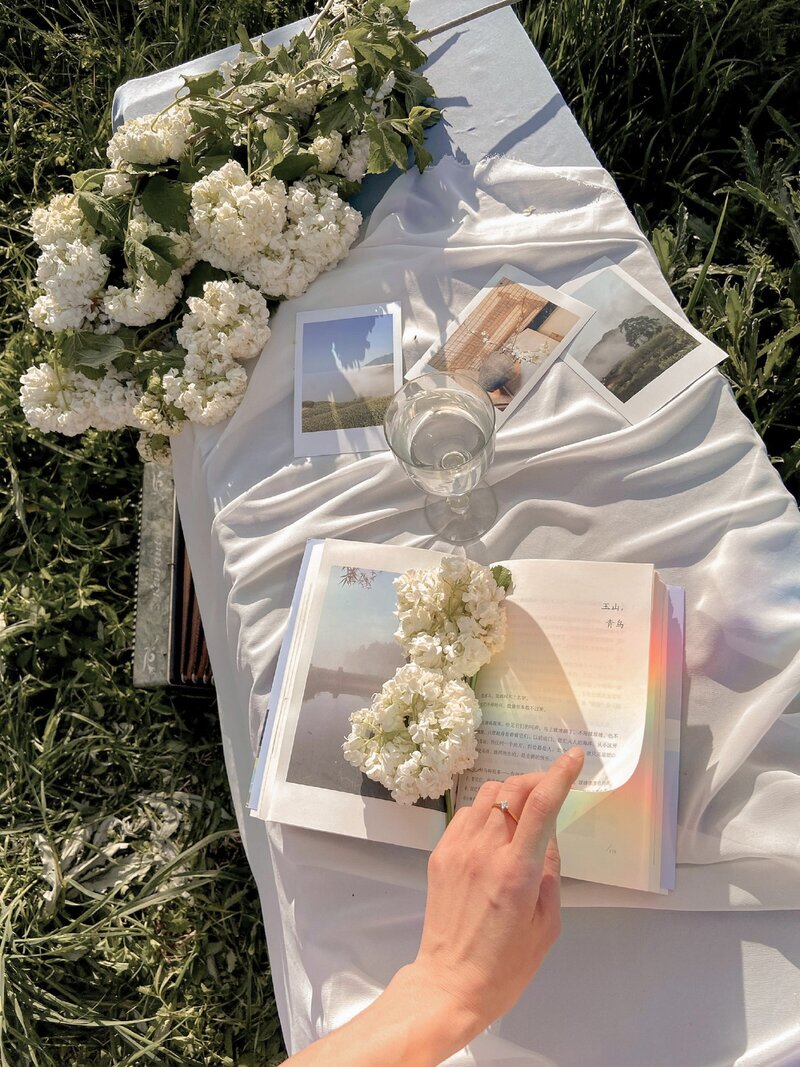 Rainbows, Books, Flowers on the grass in a magical afternoon setting