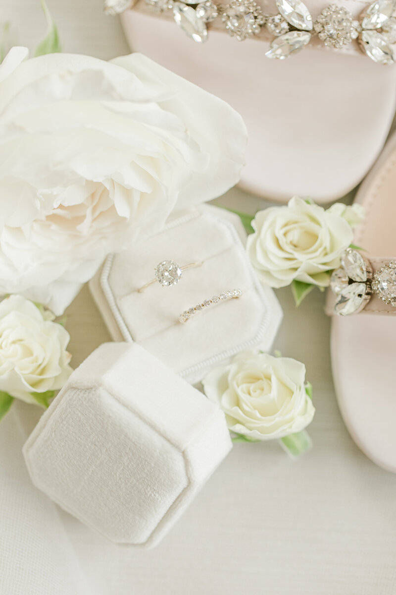 Wedding ring set in a white velvet box with white florals