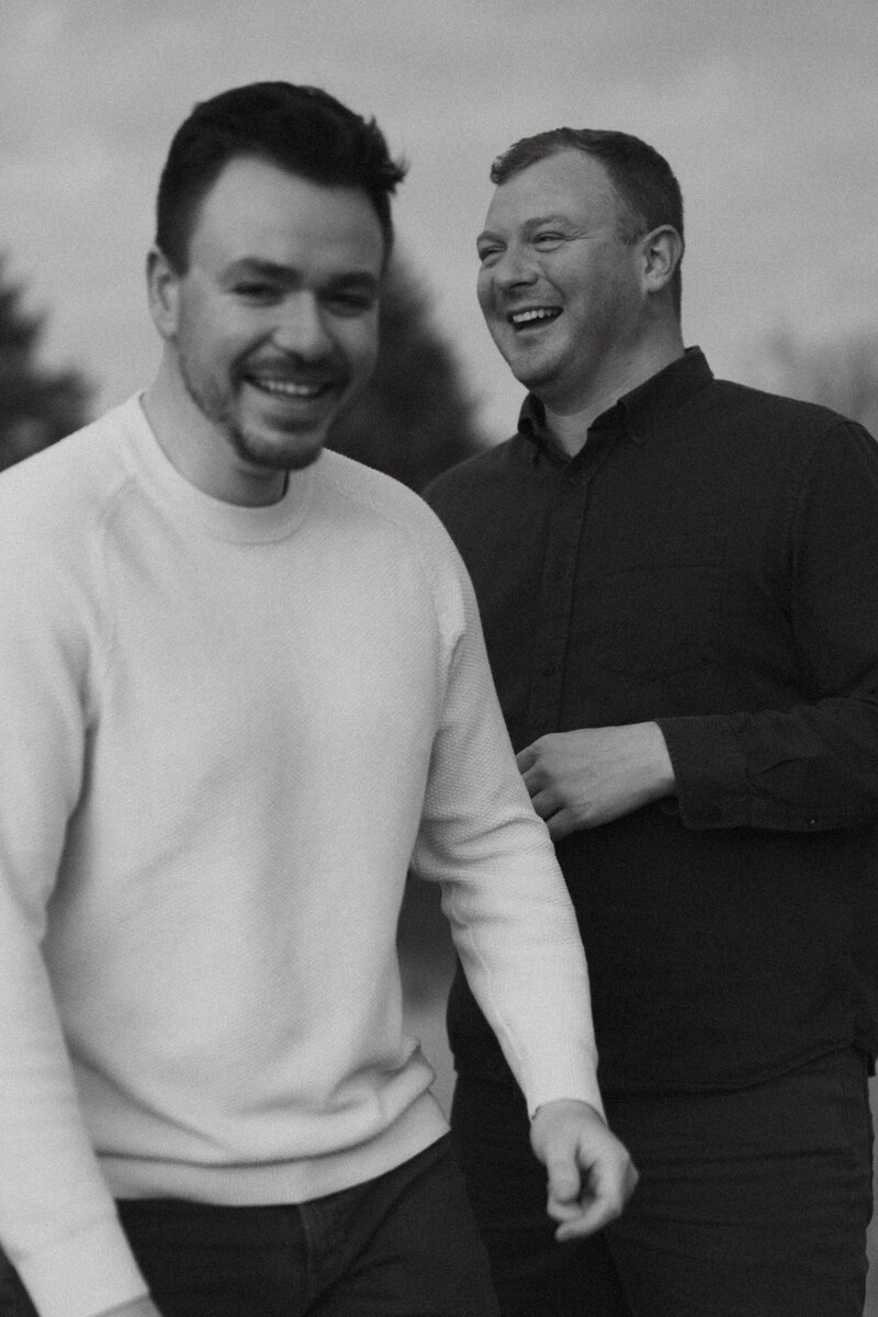 gay couple laughing in black and white