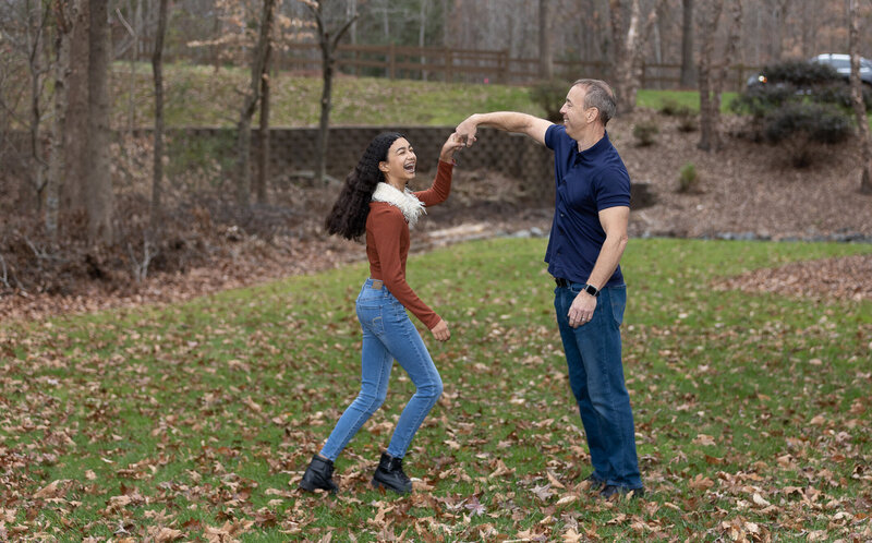 FATHER AND DAUGHTER PLAYING IN THE BACKYARD