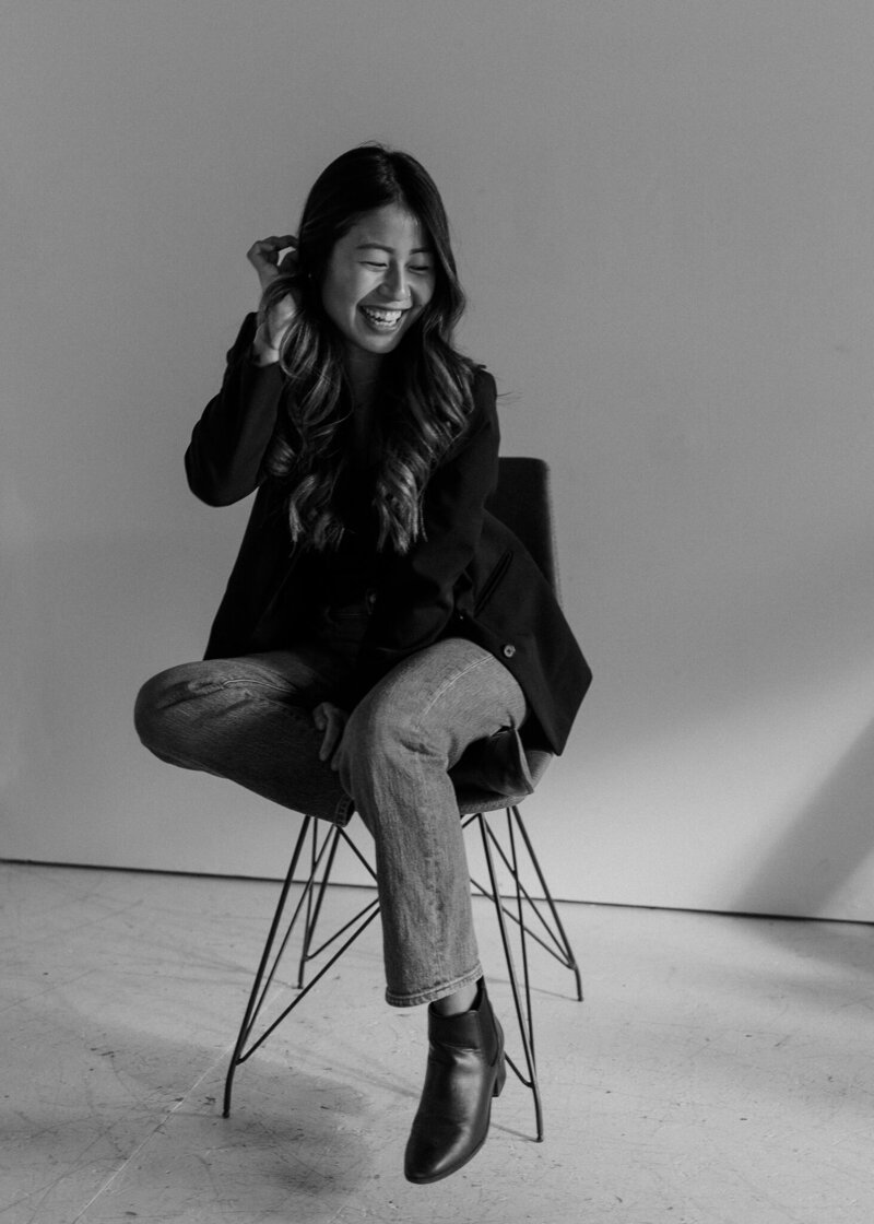 Vermont Wedding Photographer | Sincerely Liz Photography Documentary Wedding, Engagement, Elopement, Maternity and Newborn Photographer in New England | Photo of Liz Bashaw sitting and smiling in black and white