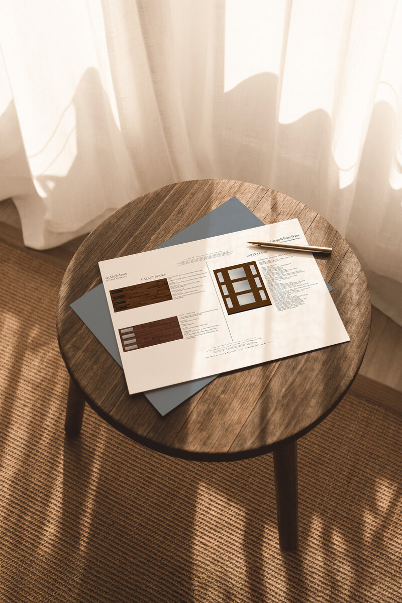 exterior design plans and paint swatches on top of a wood stool