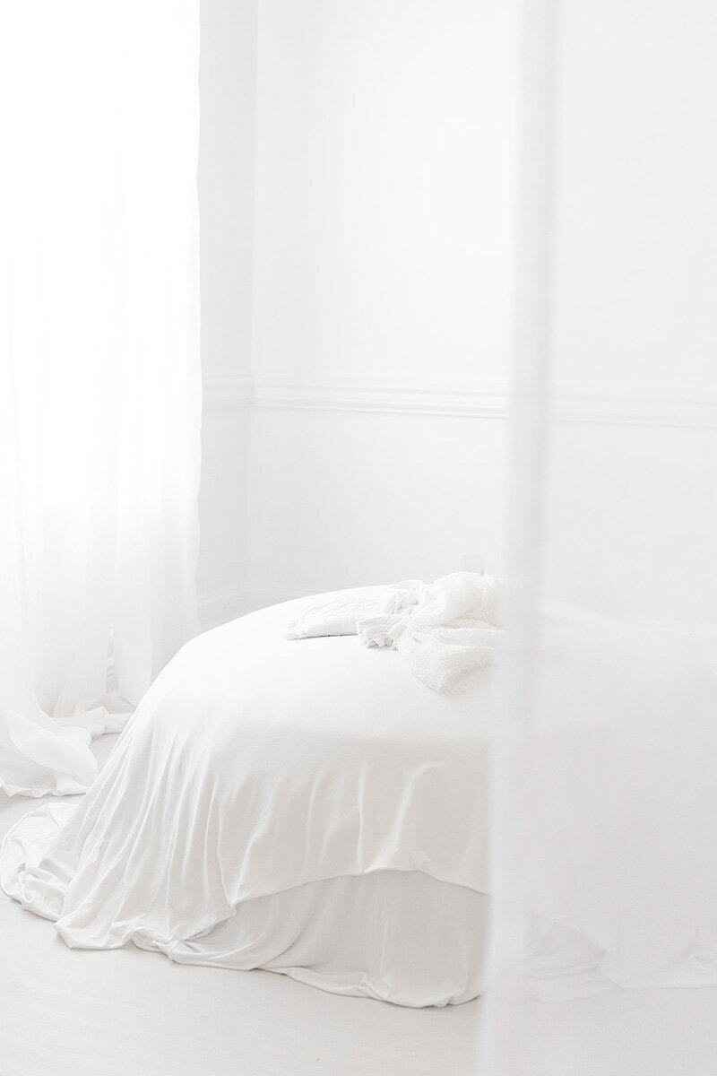 All-white studio bean bag setup at Andrea Krey Photography for newborn and maternity sessions in Destin, FL