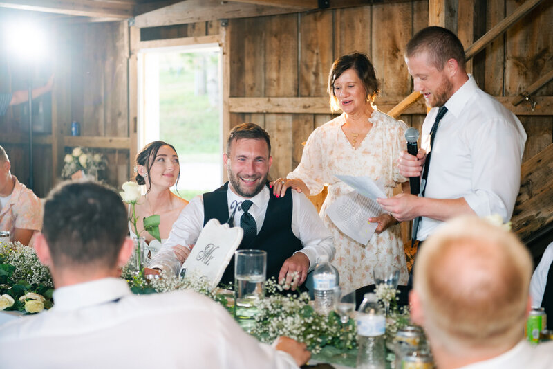 man delivers toast at wedding reception