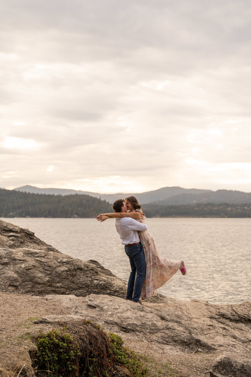 photo of engaged couple near a lake taken by photographers idaho