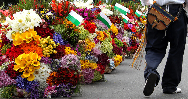 Man walks by Beautiful and vibrant flower market