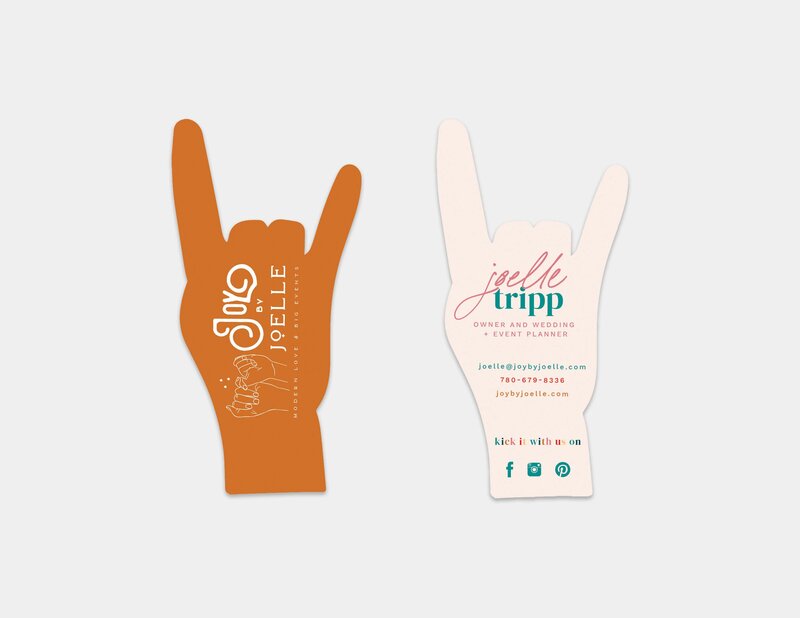 Mockup of custom designed business cards cut out into rock on hands.