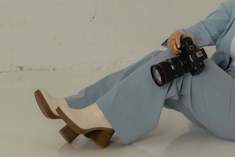 detail shot of kenzie pellerin's shoes and camera