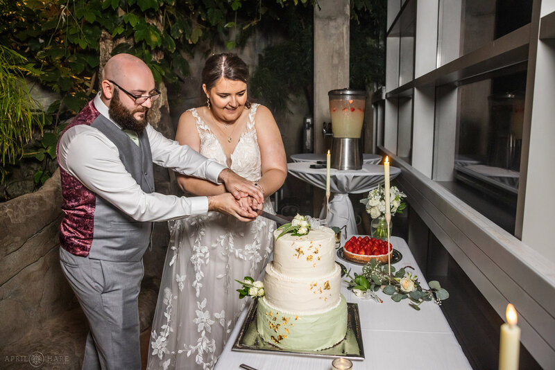 Couple cut their wedding cake at their Marnie's Pavilion wedding reception