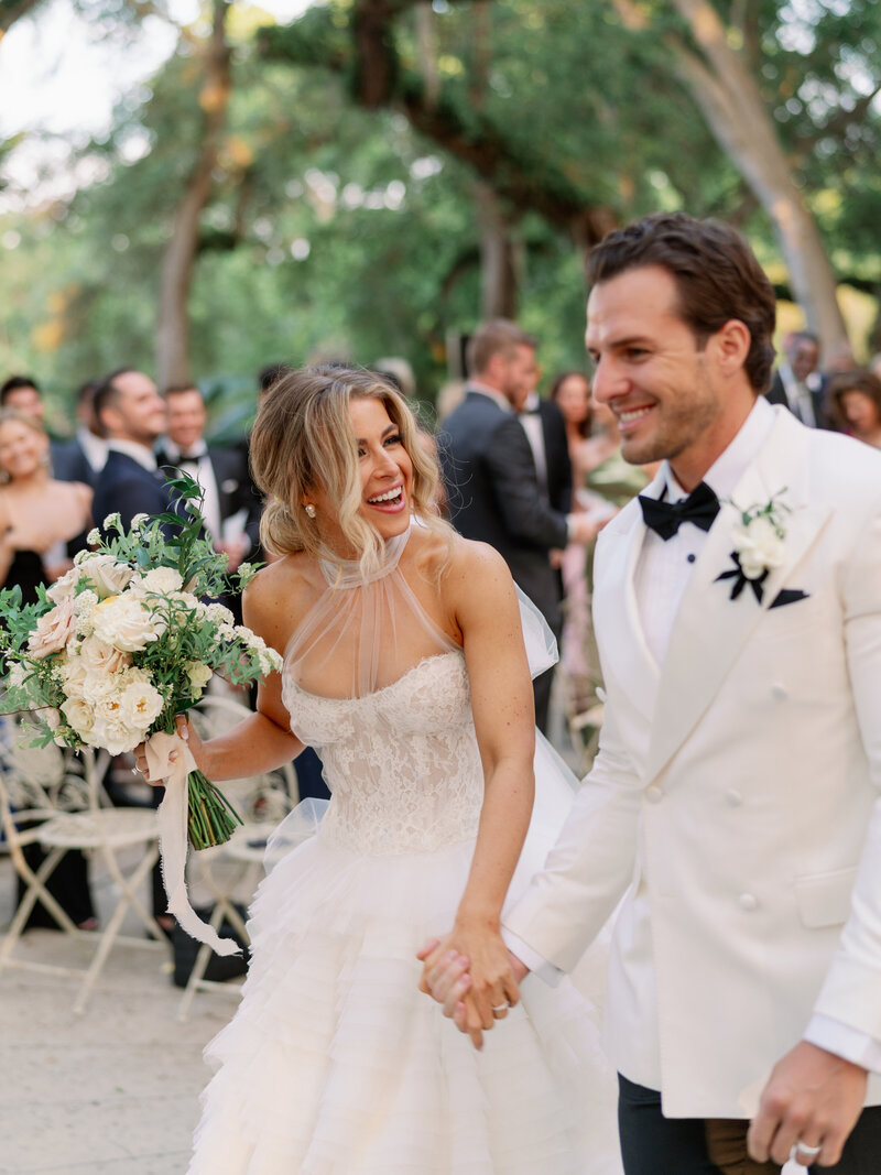 Bride and groom laughing candidly at Vizcaya Museum in Miami