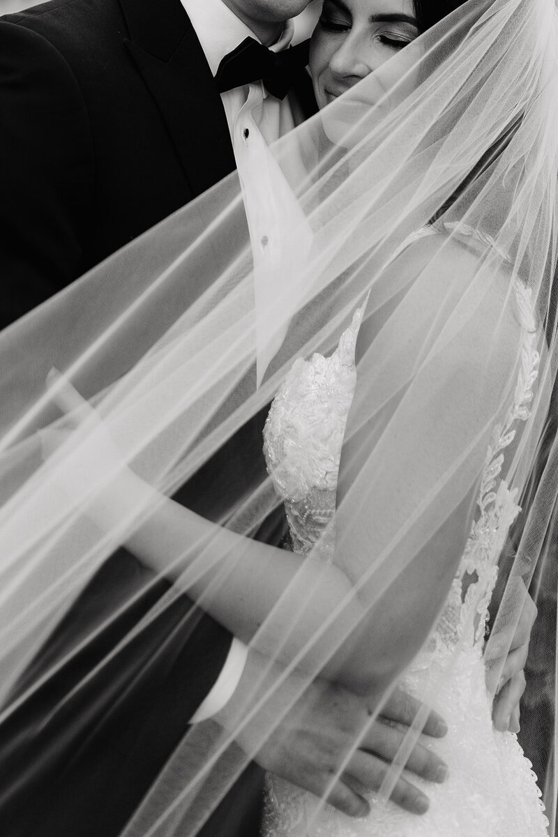 bride standing in tall room in her wedding dress