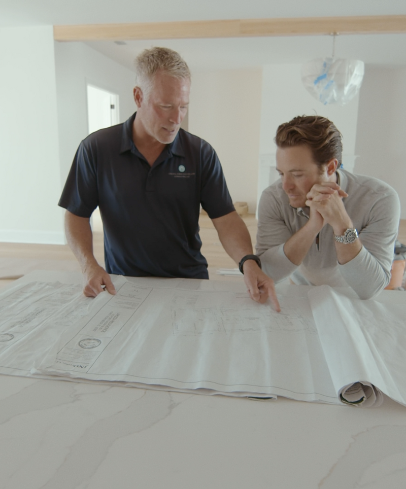 men looking at blueprints