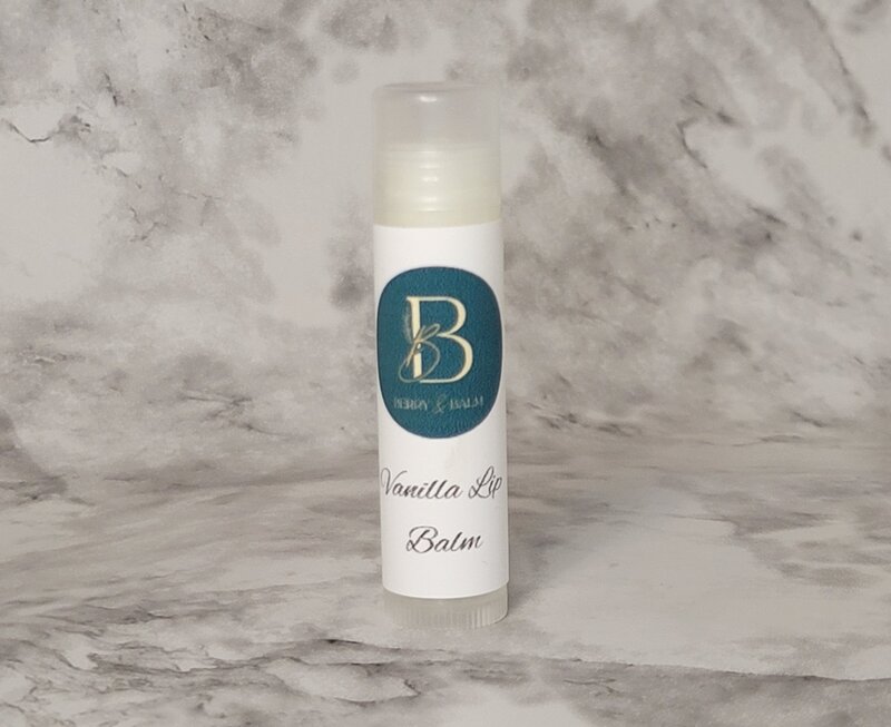 Tube of Vanilla Lip balm on a marble counter display to show its natural ingredients