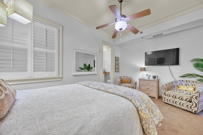bedroom with queen bed and arm chair