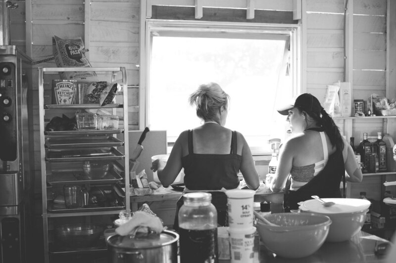 two women work on making bruschetta