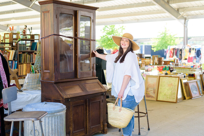 Lauren inspects antique furniture at antique mart